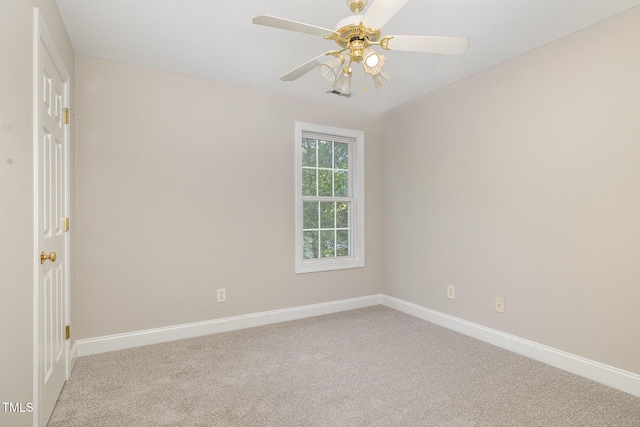 carpeted empty room with baseboards and a ceiling fan