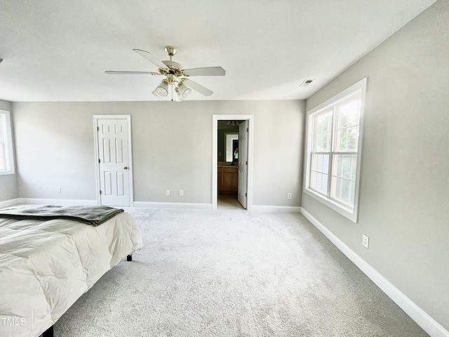 bedroom featuring a ceiling fan, baseboards, and light colored carpet