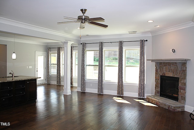 5004 Clowser Minnow Ct, Wake Forest, NC 27587 - unfurnished living room with a fireplace, a ceiling fan, dark wood finished floors, ornate columns, and recessed lighting