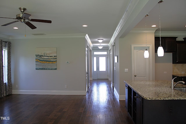 5004 Clowser Minnow Ct, Wake Forest, NC 27587 - kitchen with dark wood-style flooring, light stone counters, open floor plan, ceiling fan, and pendant lighting