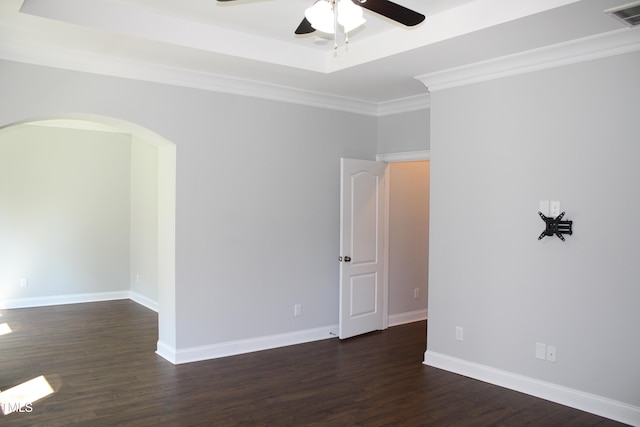 5004 Clowser Minnow Ct, Wake Forest, NC 27587 - empty room with ceiling fan, arched walkways, dark wood-type flooring, crown molding, and a tray ceiling