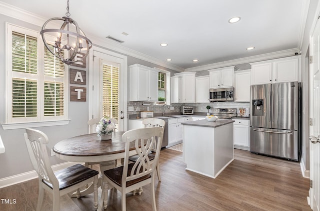 1209 Shasta Daisy Dr, Wake Forest, NC 27587 - kitchen featuring stainless steel appliances, a chandelier, healthy amount of natural light, white cabinets, and recessed lighting