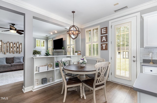 1209 Shasta Daisy Dr, Wake Forest, NC 27587 - dining space featuring wood finished floors, a chandelier, ceiling fan, crown molding, and healthy amount of natural light