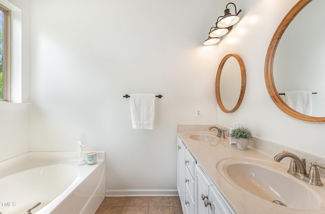 1209 Shasta Daisy Dr, Wake Forest, NC 27587 - full bathroom featuring tile patterned floors, baseboards, a garden tub, and double vanity
