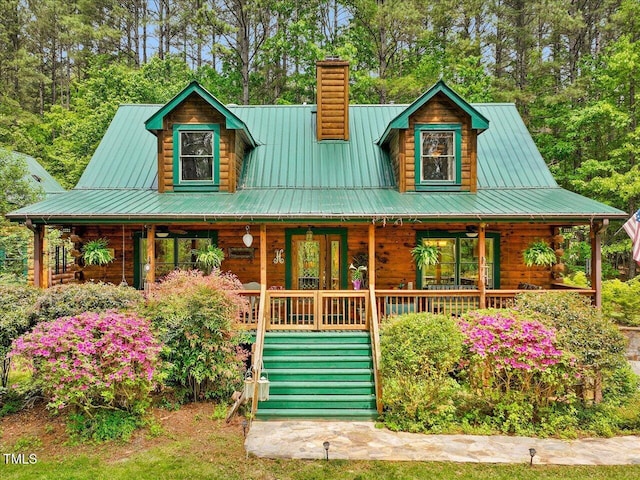 3009 Pleasant Hill Church Rd, Siler City, NC 27344 - log home featuring covered porch, log siding, a chimney, and metal roof