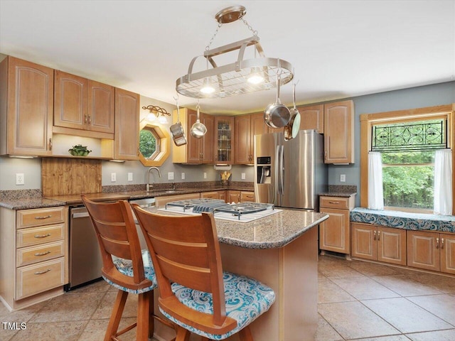 3009 Pleasant Hill Church Rd, Siler City, NC 27344 - kitchen featuring stainless steel appliances, a center island, a sink, light stone countertops, and glass insert cabinets