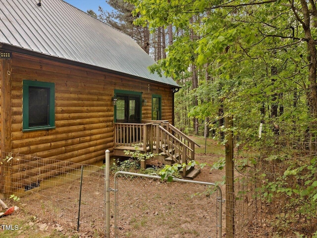 3009 Pleasant Hill Church Rd, Siler City, NC 27344 - view of side of property featuring fence, log veneer siding, metal roof, and a gate