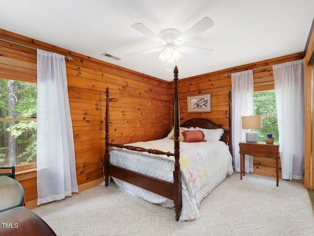 3009 Pleasant Hill Church Rd, Siler City, NC 27344 - carpeted bedroom with multiple windows, wooden walls, and a ceiling fan