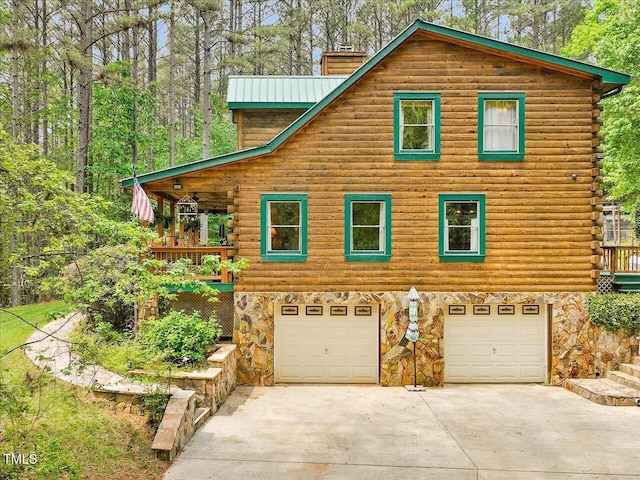 3009 Pleasant Hill Church Rd, Siler City, NC 27344 - view of front of home with a chimney, driveway, a garage, log exterior, and stone siding