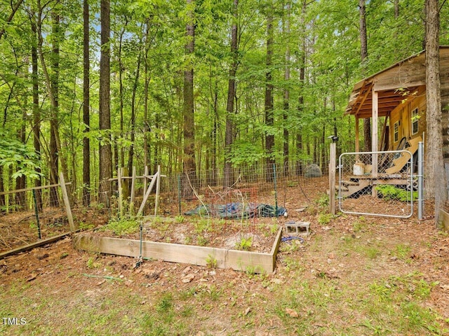 3009 Pleasant Hill Church Rd, Siler City, NC 27344 - view of yard with a vegetable garden, fence, a gate, and a wooded view