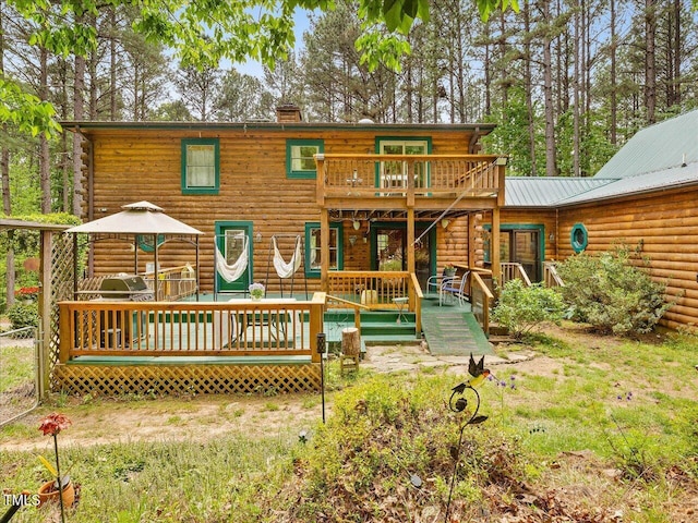 3009 Pleasant Hill Church Rd, Siler City, NC 27344 - rear view of property featuring log siding, a chimney, a deck, and a lawn