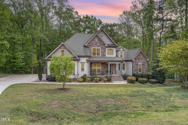 1710 Eddy Ct, Franklinton, NC 27525 - craftsman inspired home featuring a porch, a shingled roof, a front lawn, stone siding, and concrete driveway