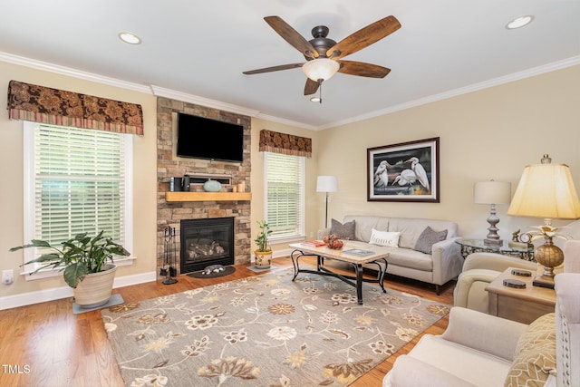 1710 Eddy Ct, Franklinton, NC 27525 - living room featuring ceiling fan, baseboards, crown molding, wood finished floors, and a fireplace