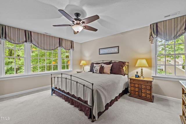 bedroom featuring baseboards, carpet flooring, ceiling fan, and a textured ceiling