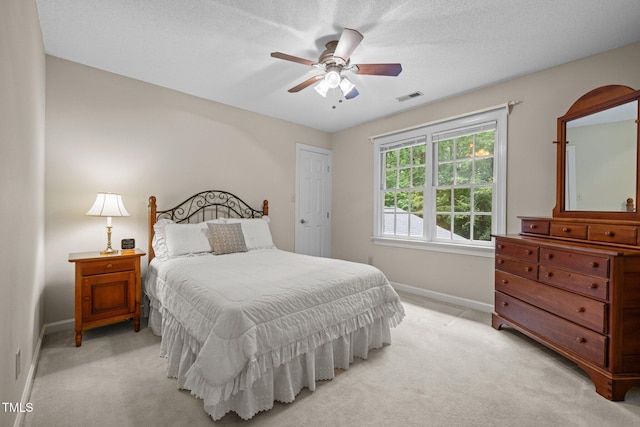 bedroom featuring baseboards, light carpet, and a ceiling fan