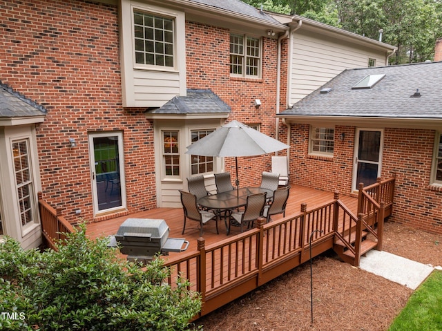 wooden terrace with outdoor dining area