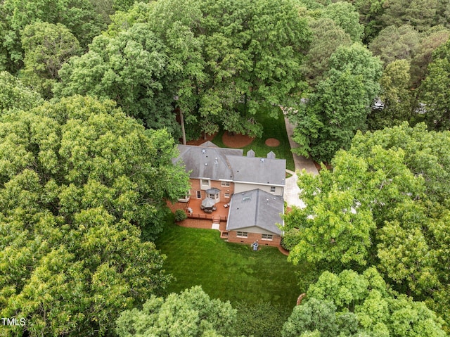 view from above of property with a heavily wooded area
