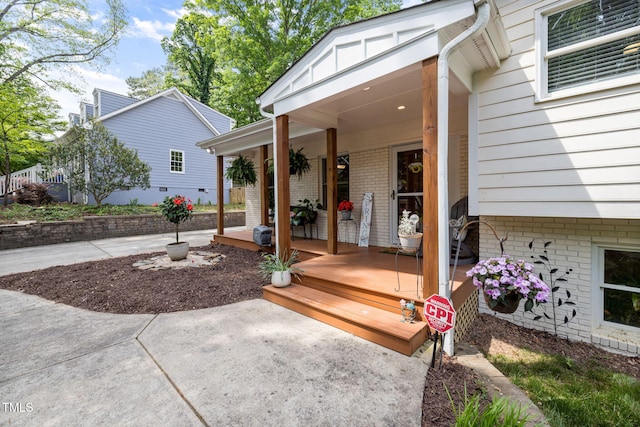 exterior space with brick siding and a porch