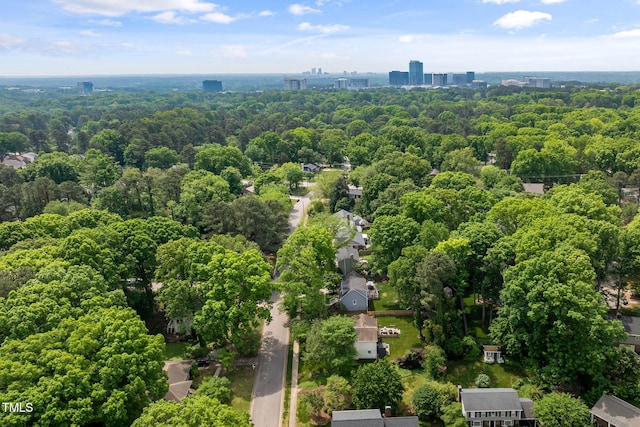 birds eye view of property with a wooded view