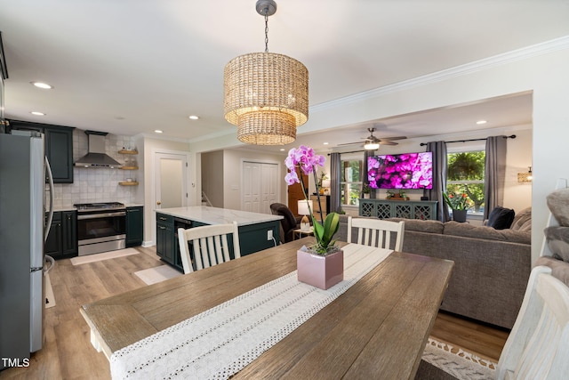dining area featuring recessed lighting, light wood-style floors, and crown molding