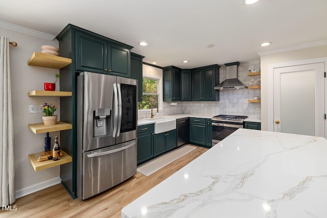 kitchen featuring open shelves, wall chimney range hood, ornamental molding, a sink, and appliances with stainless steel finishes