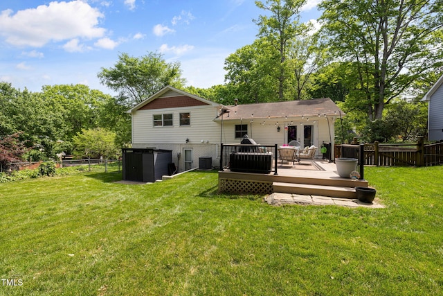 rear view of house featuring a fenced backyard, a yard, cooling unit, and a deck