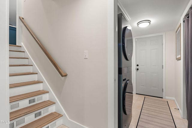 5505 Knollwood Rd, Raleigh, NC 27609 - washroom with stacked washer and clothes dryer and light tile patterned floors