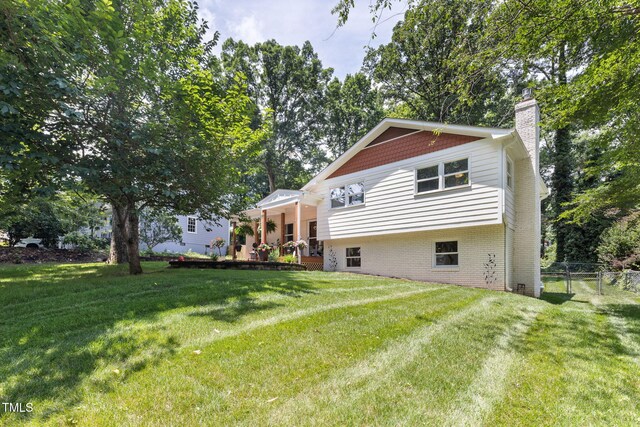 5505 Knollwood Rd, Raleigh, NC 27609 - back of house featuring a chimney and brick siding