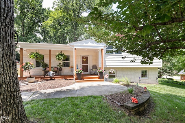 5505 Knollwood Rd, Raleigh, NC 27609 - view of front of property with a porch, brick siding, and a front lawn