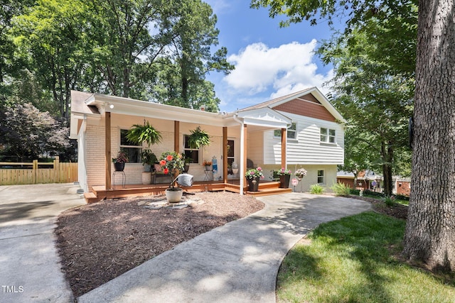 5505 Knollwood Rd, Raleigh, NC 27609 - view of front of home featuring covered porch, brick siding, and driveway