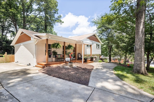 5505 Knollwood Rd, Raleigh, NC 27609 - view of front of home with a porch, concrete driveway, and brick siding