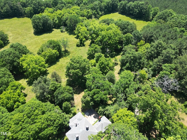 drone / aerial view with a wooded view