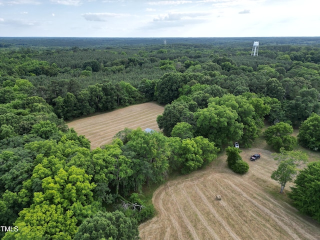 birds eye view of property featuring a wooded view