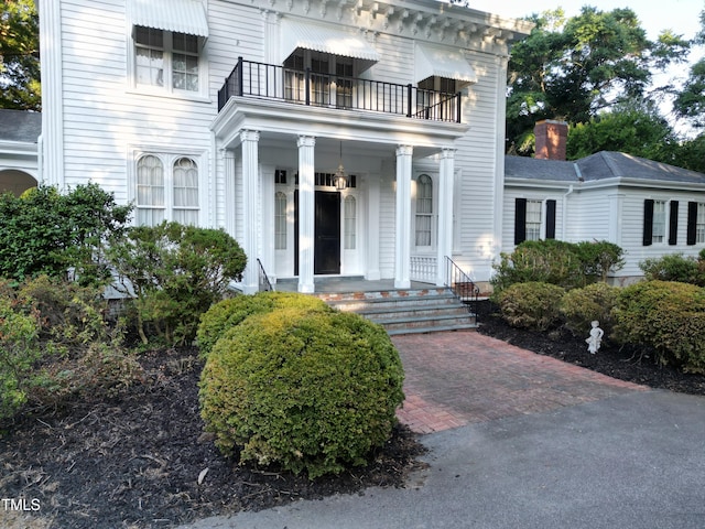 exterior space featuring a porch and a balcony