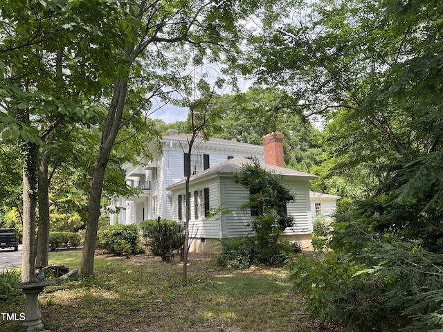 view of side of home with a chimney