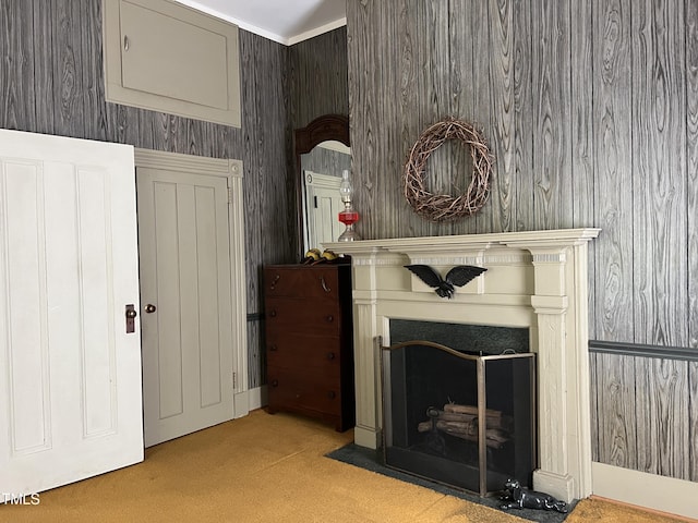 living area with a fireplace with flush hearth and carpet floors