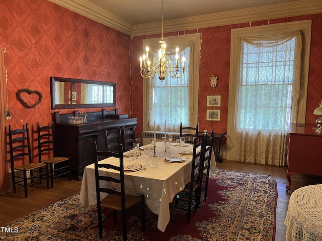dining space featuring wallpapered walls, plenty of natural light, hardwood / wood-style flooring, and an inviting chandelier