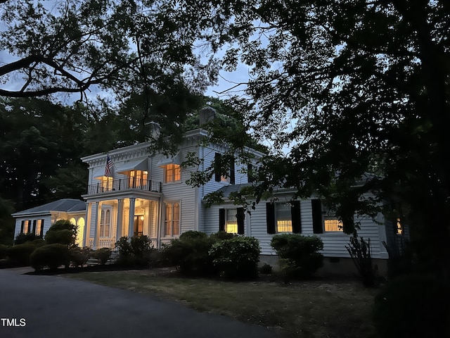 view of front of house featuring a balcony