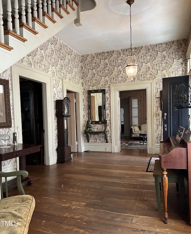 interior space featuring hardwood / wood-style floors and wallpapered walls