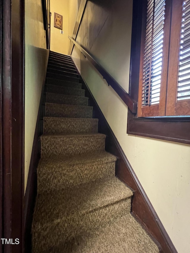 stairway featuring baseboards