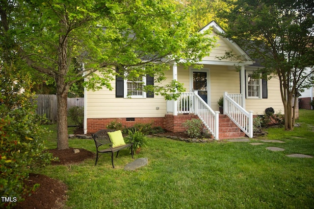 view of front of house featuring crawl space, a front lawn, and fence