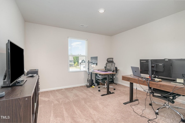 office area featuring baseboards and light colored carpet