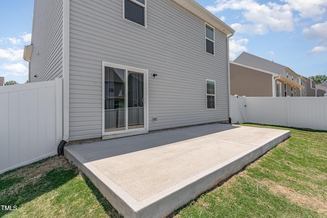 rear view of house with a patio area and fence