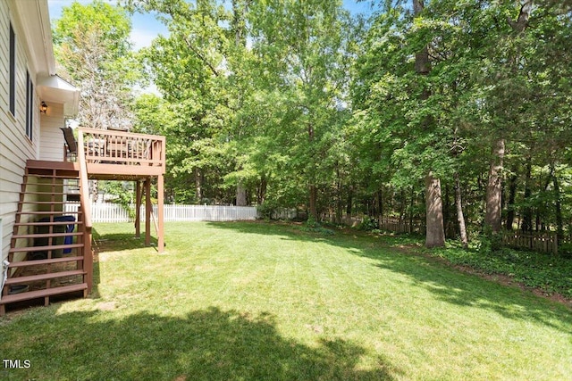 view of yard with stairs, a fenced backyard, and a deck