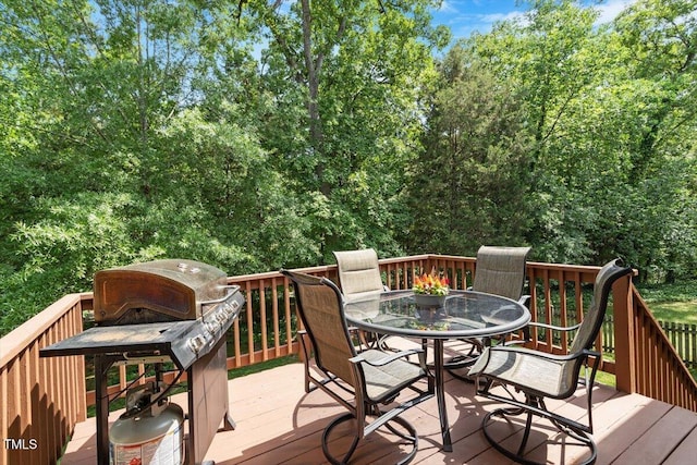 deck with outdoor dining area and a grill