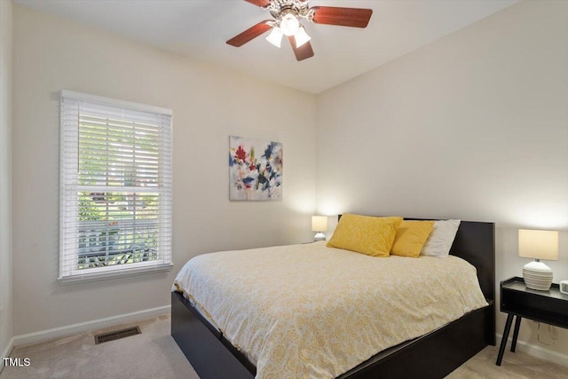 carpeted bedroom with baseboards, ceiling fan, and visible vents