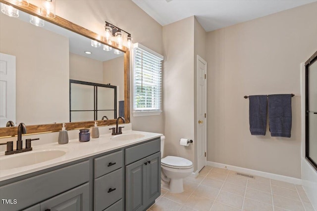 full bath featuring toilet, visible vents, a sink, and a shower with shower door