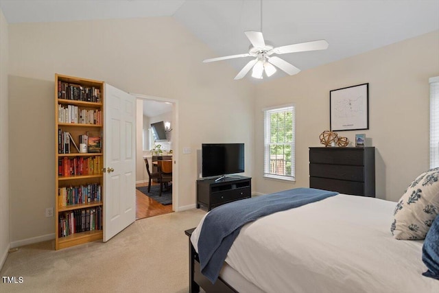 bedroom with baseboards, a ceiling fan, lofted ceiling, and light carpet