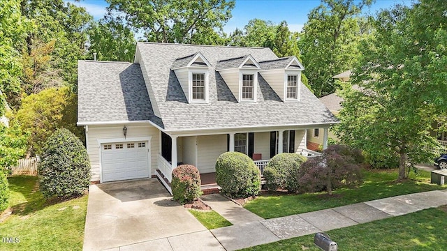 cape cod house with a shingled roof, a garage, a porch, a front yard, and concrete driveway
