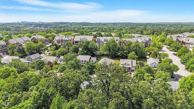 bird's eye view featuring a view of trees and a residential view